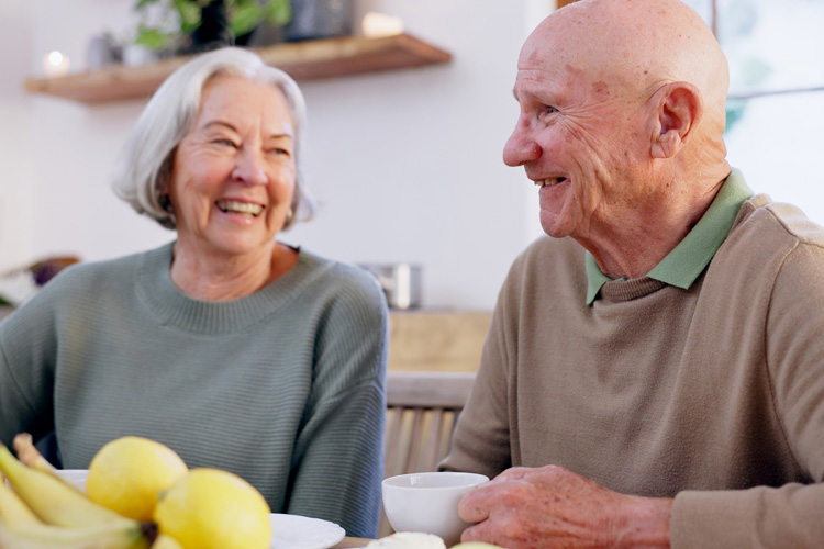 Sunny Vista Senior Living Community in Colorado Springs, CO - sunny vista senior man and woman laughing at mealtime