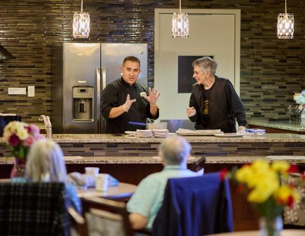 chef with resident cooking