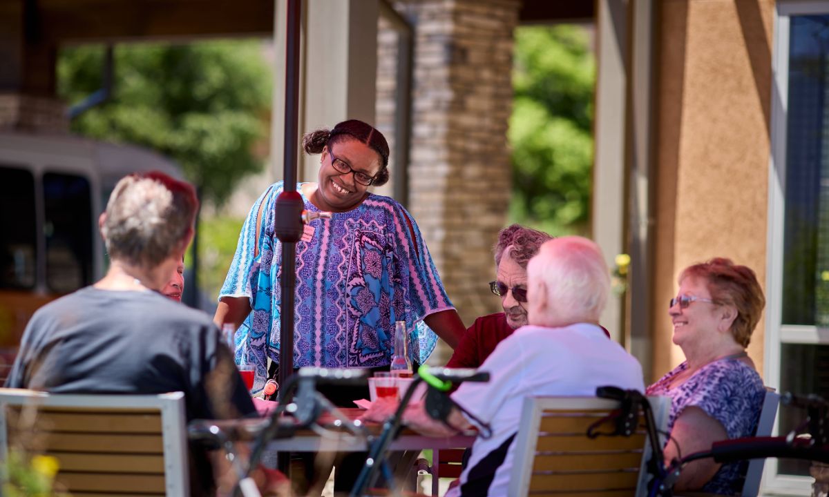 Sunny Vista Senior Living Community in Colorado Springs, CO - residents enjoying happy hour landscape