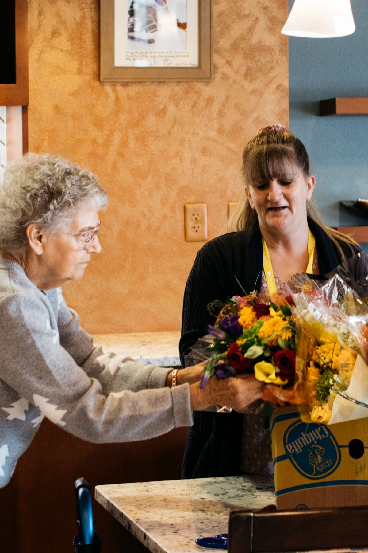Sunny Vista Senior Living Community in Colorado Springs, CO - the retreat resident and flowers portrait